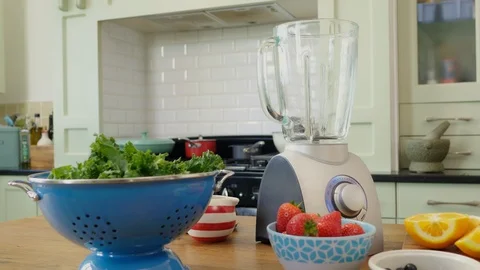 Fruits And Vegetable With Blender On Table In Kitchen Stock Footage 86116217