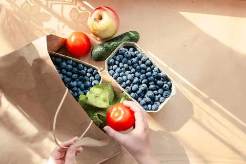Fruits and vegetables on a kitchen table bought at an organic grocery store.. Stock Photos