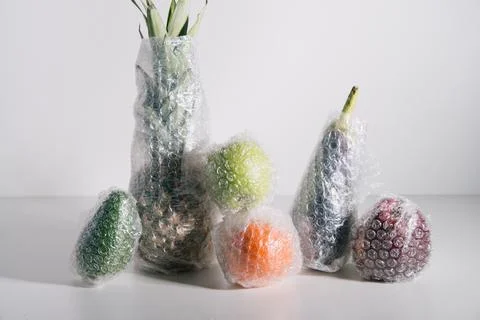 Fruits and vegetables packaged in plastic wrap Stock Photos