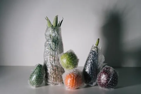 Fruits and vegetables packaged in plastic wrap Stock Photos