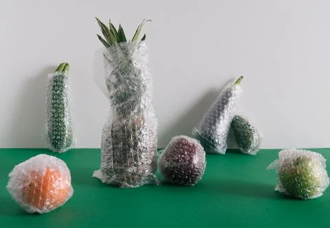 Fruits and vegetables packaged in plastic wrap Stock Photos