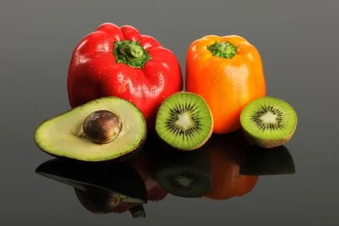 Fruits and vegetables on reflective surface Stock Photos