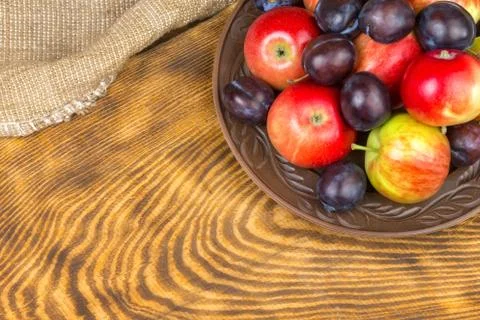 Fruits, apples and plums on a plate Foto stock