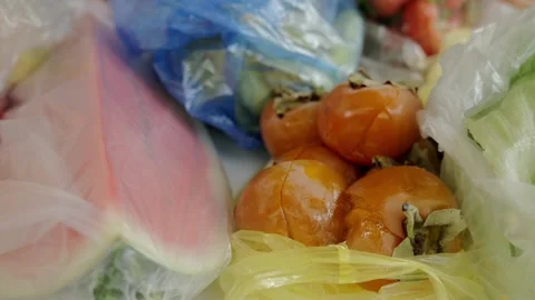 Fruits are on the table. Watermelon and persimmon are in bags on the table. Stock Footage 219277870