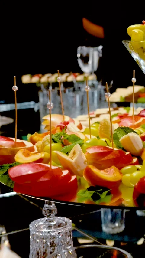Fruits, cakes, and sweets on a festive banquet table Stock Footage 346297624