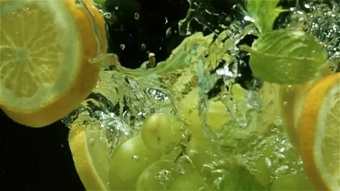Fruits fall into the water, slow motion Stock Footage 84835900