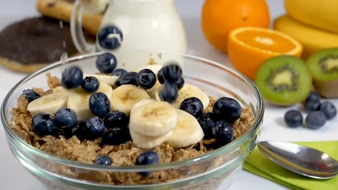 Fruits falling in slow motion on cereals flakes for breakfast Stock Footage 85357508