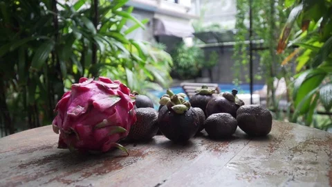 Fruits lie on a table in the background pool dragon fruit, mangosteen 库存影片 126968418