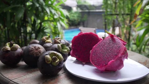 Fruits lie on a table in the background pool dragon fruit, mangosteen 库存影片 126968464