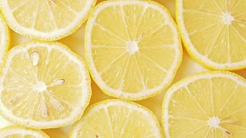 Fruits pattern, close shot. Rotative background. Yellow lemon slices, abstract Stock Footage 111723851