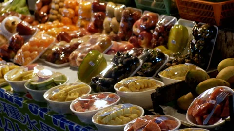 Fruits in plastic containers in a showcase at the Jomtien night food market Stock Footage 86048702