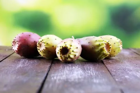 Fruits of the prickly pear cactus on a rustic table Stock Photos