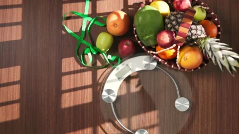 Fruits, scale, and measuring tape on wooden table, diet concept  Video stock 346170797