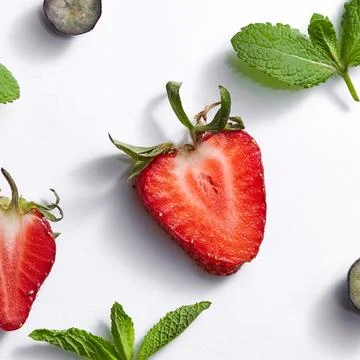 Fruits summer pattern with ripe strawberry, blueberry, leaf of mint on a wh.. Stock Photos