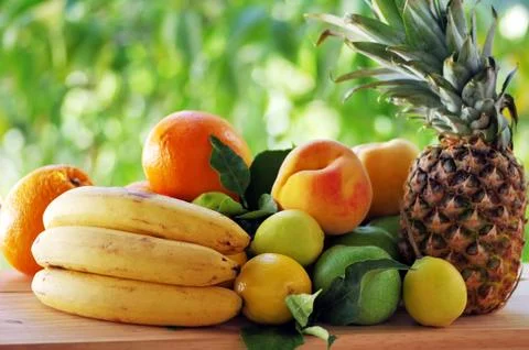 Fruits on table, green background Stock Photos