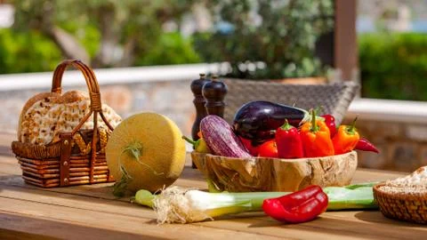 Fruits, vegetables and bread on the table in the summer garden Stock Photos