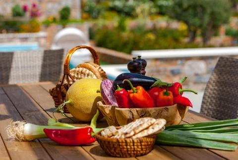 Fruits, vegetables and bread on the table in the summer garden Stock Photos