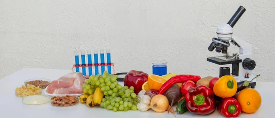 Fruits vegetables and microscope in science lab setting Stock Photos