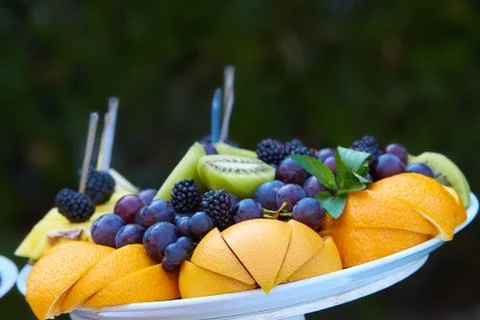 Fruits on wedding table at restaurant. Composition of colored fruit Stock Photos