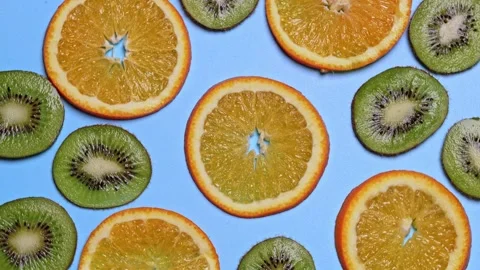 Fruity background set of slices of orange fruit and kiwi rotates on a turntable Stock Footage 159445814