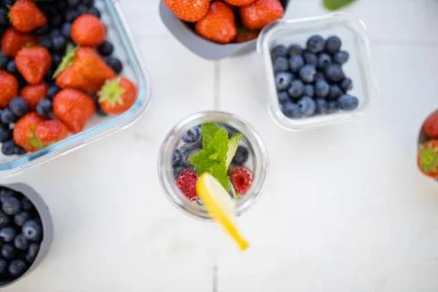 Fruity beverage inside lemon slice on the edge from above Stock Photos