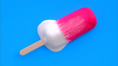 Fruity ice cream melting on a blue background . Stock Footage