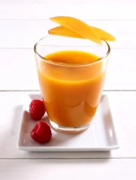 Fruity mango smoothie with raspberry Stock Photos