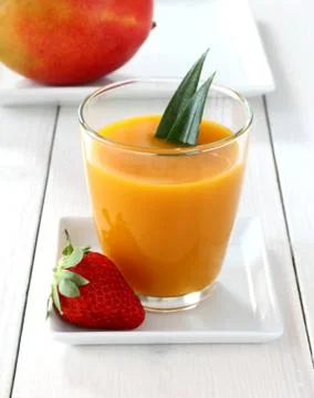 Fruity mango smoothie with strawberry Stock Photos