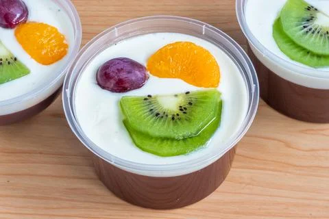 Fruity milk pudding, sweet chocolate silk pudding dessert with fruit topping Stock Photos