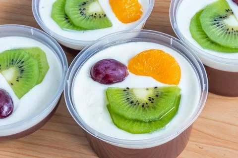 Fruity milk pudding, sweet chocolate silk pudding dessert with fruit topping Stock Photos