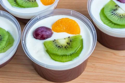 Fruity milk pudding, sweet chocolate silk pudding dessert with fruit topping Stock Photos