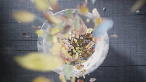 Fruity Pebbles cereal breakfast falls into bowl w/ milk being poured in slo-mo Stock Footage 154217730