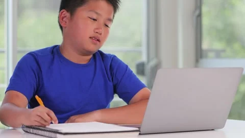 Frustrated 12 year old boy working on his school homework Video stock 250028336