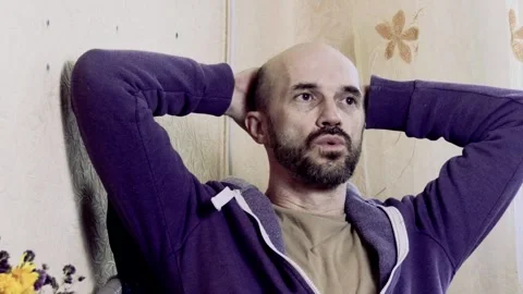 Frustrated and Thoughtful Middle-Aged Man sitting with Closed Eyes in Despair Stock Footage 338381755