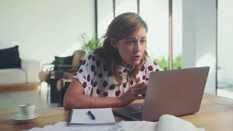 Frustrated annoyed young woman confused by computer problem Stock Footage