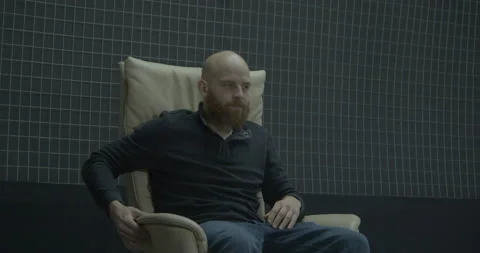 Frustrated bearded man feels bad turning around in armchair Stock Footage 170151644