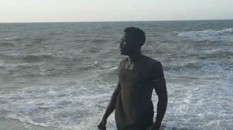 A frustrated black guy at the beach 05 Video stock 67556828