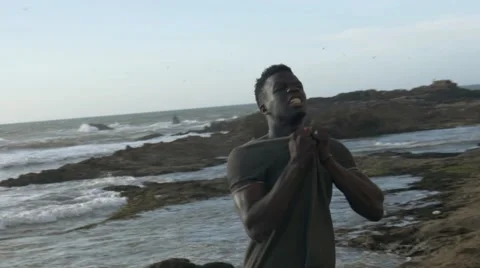 A frustrated black guy at the beach 06 Video stock 67556461