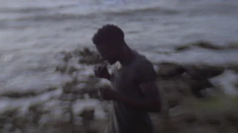 A frustrated black guy at the beach Video stock 67522870