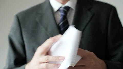 Frustrated business man destroying a document or sheet of paper with his hands. Stock Footage 152480196