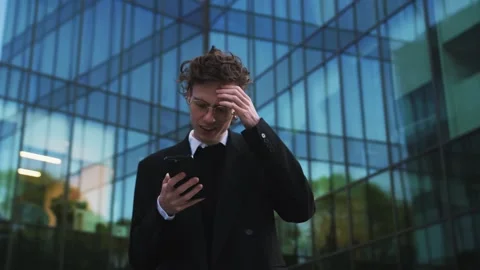 Frustrated caucasian man getting notification on mobile phone reading bad news Stock Footage 242943037