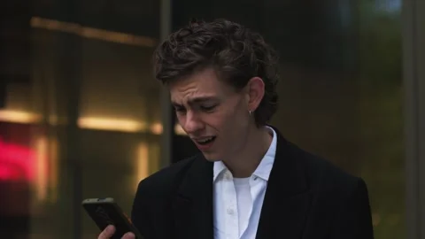 Frustrated caucasian man getting notification on mobile phone reading bad news Video stock 242951281