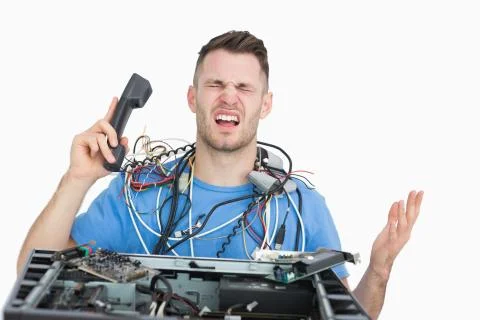 Frustrated computer engineer on call in front of open cpu Foto stock