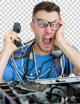 Frustrated computer engineer screaming while on call in front of open cpu Stock Photos