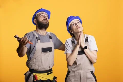 Frustrated Construction Workers Looking Up in Despair Stock Photos