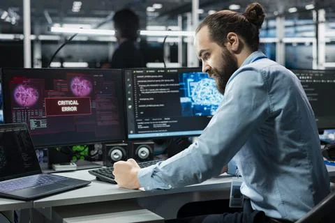 Frustrated data center programmer smashing desk, upset by malfunctioning gear 스톡 사진