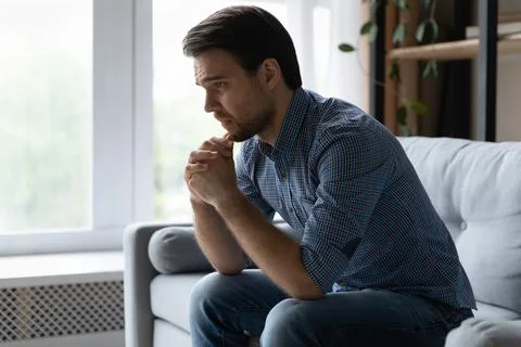 Frustrated desperate young man coping with loss, grief Stock Photos