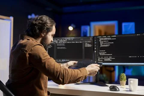 Frustrated developer ready to smash keyboard after finding code errors Stock Photos