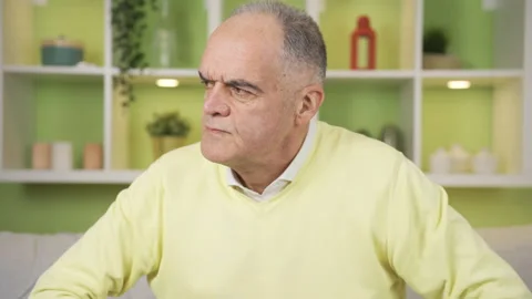 Frustrated grumpy old man getting angry at home. Video stock 235619998