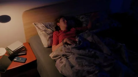 Frustrated kid hiding under blanket in bed struggling with morning awakening Stock-Footage 336669727